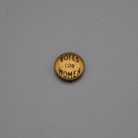 round, gold button with text "Votes for Women"